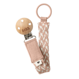 BIBS braided pacifier clip in blush pink and white, with a wooden clip and ring.