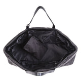 Open black quilted tote bag with a matching small pouch inside, showing spacious interior.