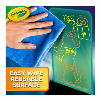 Hand wiping a glowing Crayola Multi-Color Light LCD Board with a blue cloth, showing an "Easy Wipe Reusable Surface" feature.