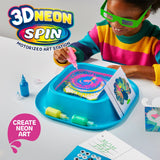 Child in neon green glasses creating spin art with pink paint on a blue motorized station, surrounded by bright paints.