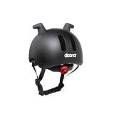 Doona Liki Helmet Black with unique silicon horns, vents, adjustable chin strap, and red rear light.