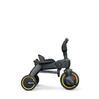 Doona Liki Trike S3 kids tricycle, dark gray with yellow wheel accents and a blue seat.