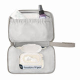 Open gray Ergobaby portable changing pad with wipes, cream, and spray bottle inside.