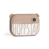 Hoppstar Artist Memo Camera Set: a beige, bear-eared instant camera with "Hoppstar" logo.
