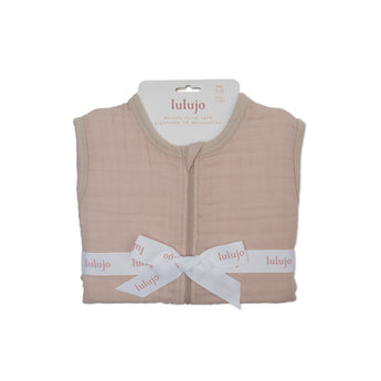 Lulujo 1.0 TOG light pink 100% cotton muslin sleep sack, folded with white logo ribbon.