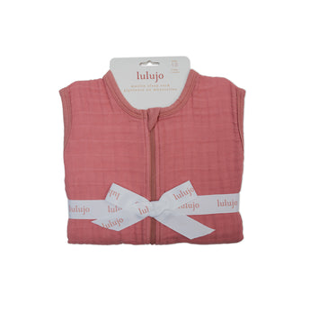 Lulujo 1.0 TOG pink 100% cotton muslin sleep sack, folded and tied with a white logo ribbon.