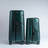 Two dark green MiaMily ride-on suitcases, one 24-inch and one smaller, with black accents and wheels.