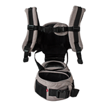 MiaMily Hipster ergonomic baby carrier in light brown fabric with black straps and hip seat.