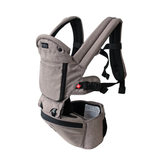 MiaMily Hipster Ergonomic Baby Carrier in light brown fabric with black straps and hip seat.