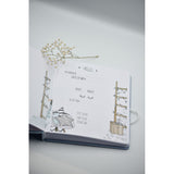 Open personalized baby milestones photo album with "HELLO" page, baby details, and cute illustrations.