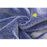 Close-up of soft, fluffy blue sleeping sack fabric with yellow star accents.