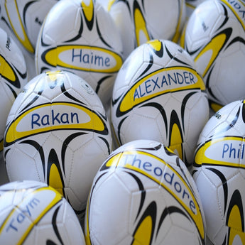 White and yellow personalized size 5 footballs with black accents, each featuring a unique name.