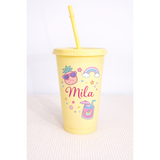 Yellow 24oz personalized tumbler with straw, featuring "Mila" and colorful pineapple, rainbow, and drink designs.