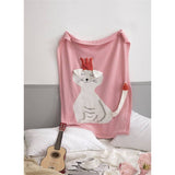 Pink personalized animal theme blanket with a white cat wearing a red crown, draped over a bed.