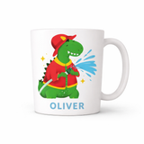 White 11 oz ceramic mug with a green dinosaur firefighter design, red hat, and "OLIVER" in blue text.