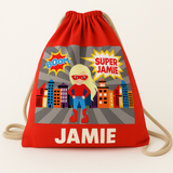 Red recycled cotton drawstring bag with a blonde superhero girl, city skyline, and "SUPER JAMIE" and "JAMIE" text.
