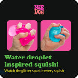Hand squeezing a blue NeeDoh Dream Drop squishy fidget toy, showing its soft, pliable texture.