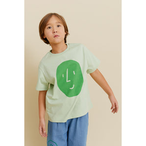 Kid wearing a light green organic cotton oversized t-shirt with a green potato face print.
