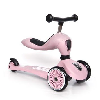 Pink Scoot & Ride Highwaykick 1 2-in-1 kickboard with seat, two front wheels, and one rear wheel.