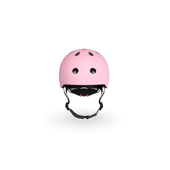 Pink Scoot & Ride kids helmet with black vents, straps, and a red magnetic fastener.