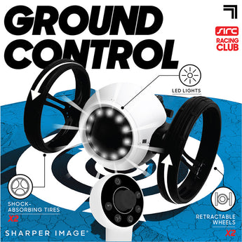 White Sharper Image RC Jumping Car with black retractable, shock-absorbing tires, LED lights, and a white remote.