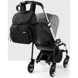 Black quilted Skip Hop Forma nappy bag backpack attached to a grey stroller.