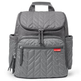 Skip Hop Forma grey quilted chevron backpack nappy bag with multiple zippered pockets and top handle.