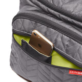 Skip Hop Forma quilted gray backpack with a gold smartphone in a front pocket, showing a lime green interior.