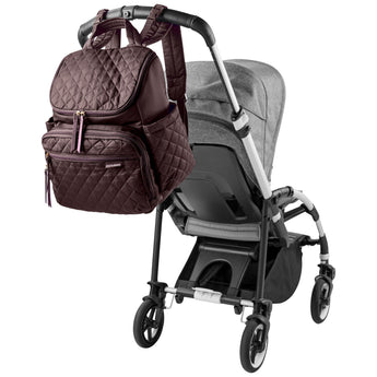 Skip Hop Forma quilted brown backpack nappy bag hanging on a gray stroller handle.