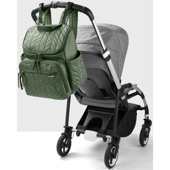 Olive green quilted Skip Hop Forma backpack nappy bag hanging from a gray stroller handle.