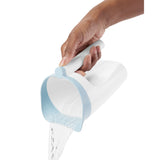 Hand holding a white Skip Hop Moby Waterfall Rinser with a light blue rubber lip, pouring water.