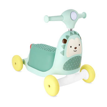 Mint green Skip Hop Zoo 3-in-1 hedgehog ride-on toy with yellow wheels and a white base.