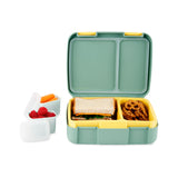 Open Skip Hop Zoo bento box in teal and yellow with sandwich and pretzels, plus two small containers with raspberries and carrots.
