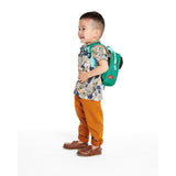 Toddler boy wearing a green Skip Hop Zoolet backpack with a bee design and detachable tether.