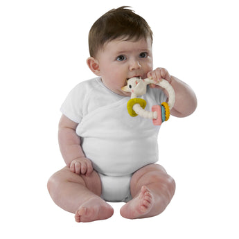 Baby in white onesie chewing a Sophie la girafe So'Pure Teething Color Rings toy.