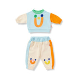 Children's outfit with a colorful top and pants on a white background