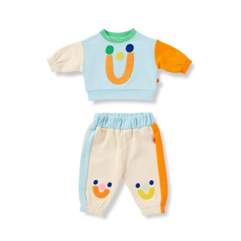 Children's outfit with a colorful top and pants on a white background