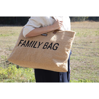 Childhome Family Tote Bag in fluffy beige teddy fabric with "FAMILY BAG" in black text, held by a person.