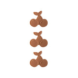 Three pairs of cherry-shaped icepacks on a white background