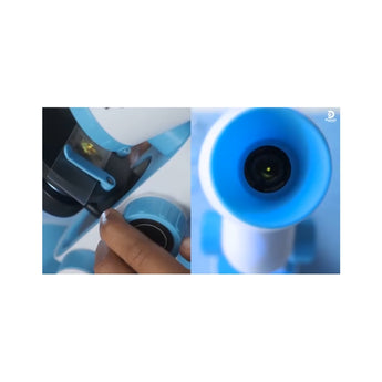 Close-up of a white and blue Discovery Kids microscope, showing a hand adjusting a knob and the eyepiece.