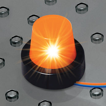 Close-up of a glowing orange LED light module with a black base, connected by blue and orange wires, on a grey circuit board.