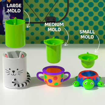 Three green plastic molds (large, medium, small) above a white cat cup, a colorful polka-dot cup, and a blue turtle cup.