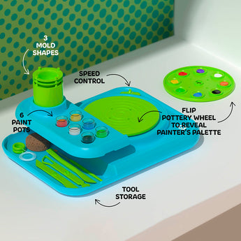 Blue and green Discovery Kids Pottery Wheel Studio with 6 paint pots, 3 mold shapes, speed control, tool storage, and a flip-top painter's palette.