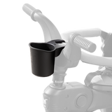 Black Doona Liki Cup Holder attached to a gray trike handlebar, designed for beverages.