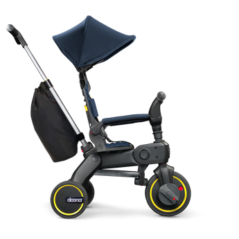 Doona Liki Trike S3 in navy blue and black with yellow accents, a canopy, and storage bag.