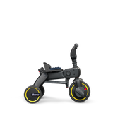 Doona Liki Trike S3 kids tricycle, dark gray with yellow wheel accents and a blue seat.
