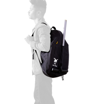 Black Doona Liki Trike Travel Bag backpack on a person's back, durable water-repellent fabric.
