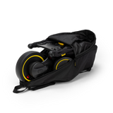 Black Doona Liki Trike Travel Bag, durable fabric, partially open with a folded Liki Trike inside.