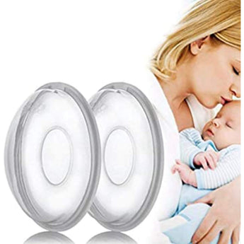 Two clear Medela breast shells with grey rims, shown next to a mother holding her baby.