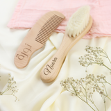 Personalized natural baby wooden hair brush and comb set with "Noora" engraved, on a white and pink background.